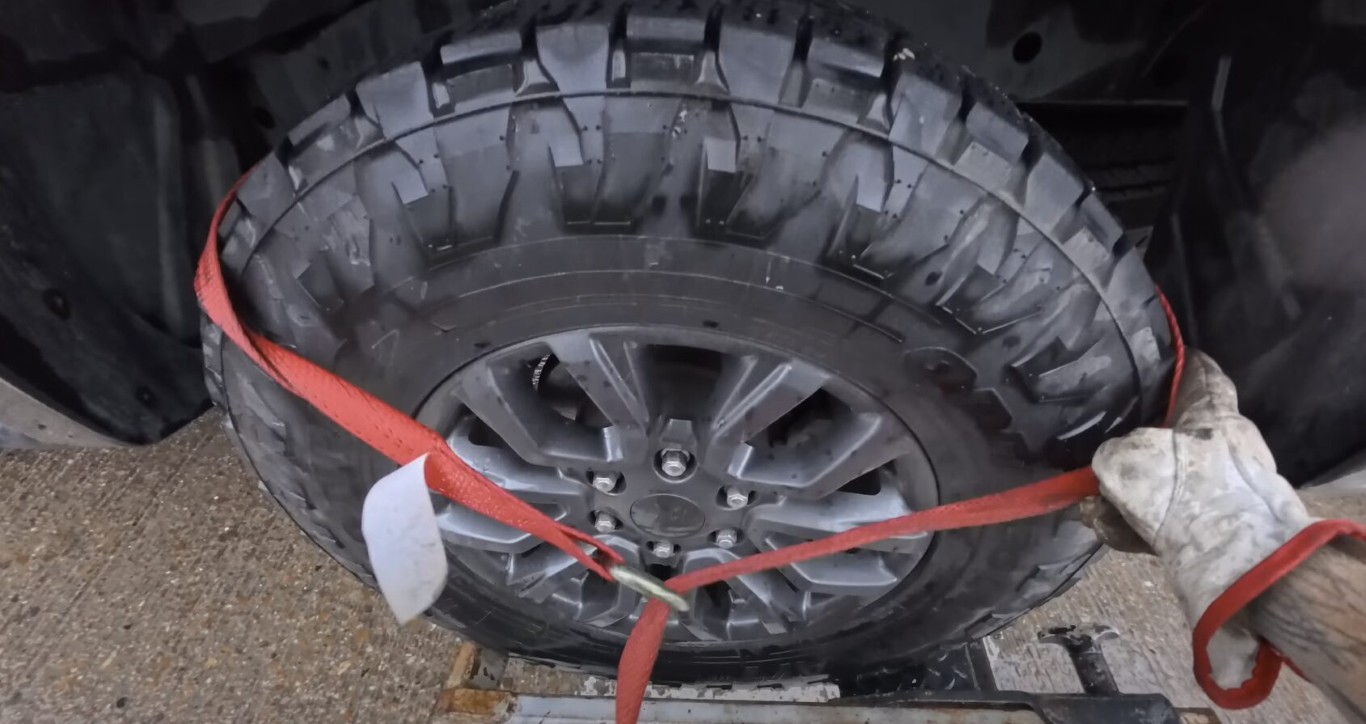 Motorcycle towing with secure tire strapping technique